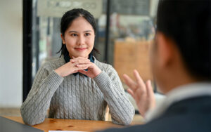 Two people having a conversation at a table.