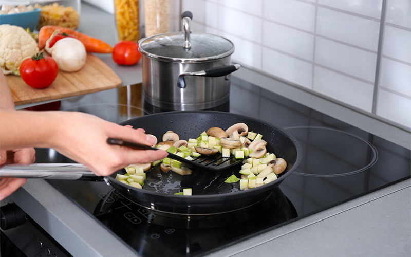 Woman cooking delicious dinner at home