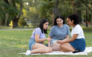 Foreign domestic workers relaxing outdoors during off-day break.